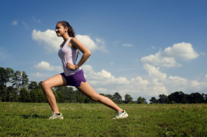 woman stretching in field