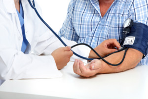 nurse tests man for blood pressure