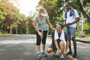 three adults talk to each other while preparing to exercise