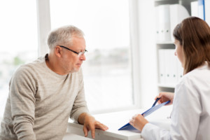 man visiting with his female doctor