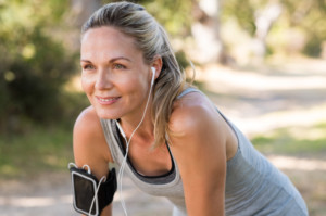 Woman smiles while taking a break during her workout