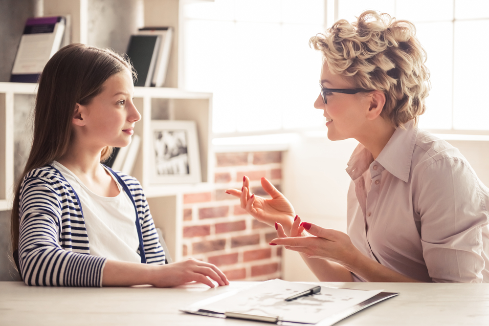 therapist speaking with a teen