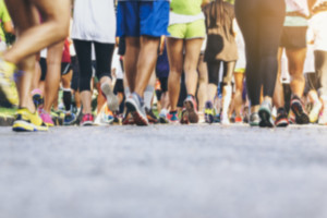 large group of people walk in a marathon