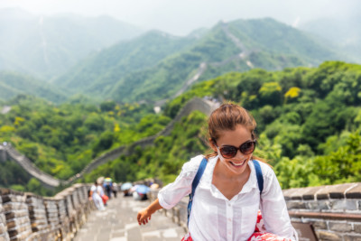 A woman smiles as she explores while on vacation