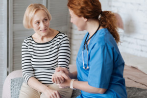 A nurse checks her patients resting heart rate