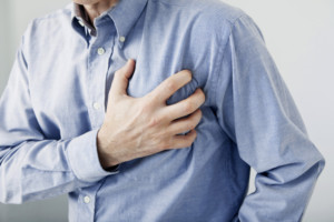 A man grabs his chest in pain