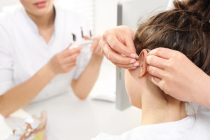 A patient getting fitted for a hearing