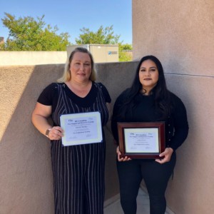 Two women holding up their Certificate for graduating